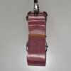 A pink strap with yellow thread on it.