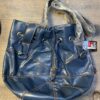 A blue purse with some tags on it
