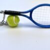 A tennis racket and ball are on the table.